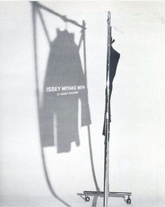 an old photo of a dress hanging on a clothes line with the words issey mixxc men