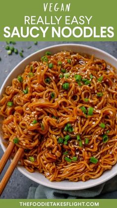 a bowl full of noodles with chopsticks in it and text overlay that reads vegan really easy saucy noodles