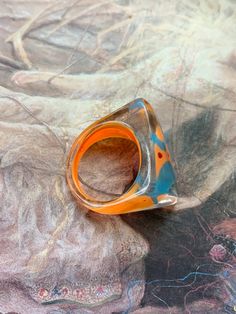 "WHAT A STATEMENT RING...A beautiful vintage 90s vogue ring made of LUCITE. This Y2K ring is NOS...new old stock, never been worn. Awesome dimension with a stunning pattern Size: 6.5 Measurements: 5/8\" wide, 1\" tall from the base to the top (circumference) Just about a 1/4\" rise above the finger Condition: MINT Wonderful warehouse old stock jewelry find! Bring this beauty back into circulation and enjoy an amazing conversation piece! I have a few of these in different colors and styles... inq Vintage Orange Rings For Collectors, Vintage Multicolor Rings For Gifts, Vintage Multicolor Rings For Gifting, Vintage Multicolor Rings For Gift, Vintage Multicolor Rings As Gift, Retro Handmade Adjustable Ring, Handmade Adjustable Retro Rings, Handmade Retro Rings As Gift, Retro Multicolor Rings For Gift