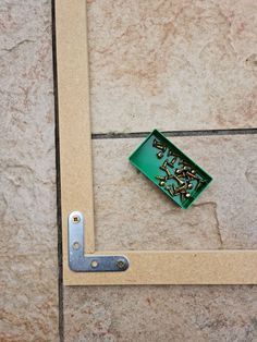 there is a green box with screws in it on the floor