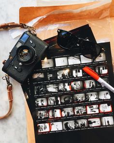 an old camera and some other items on a table