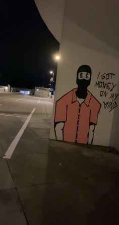 a man wearing a gas mask is painted on the side of a building at night