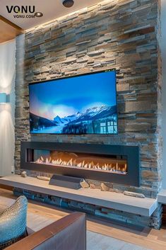 a living room with a large television mounted on the wall and fireplace in front of it