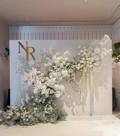 an arrangement of white flowers on display in a room