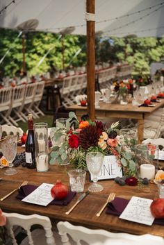 the table is set with place cards and wine glasses for guests to sit down at