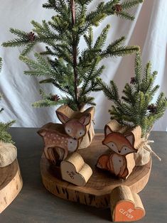 two small wooden deer ornaments sitting on top of a table