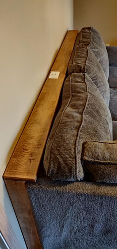 a couch that is sitting on top of a carpeted floor next to a wall