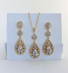 Super sparkly clear cubic zirconia bridal tear drop earrings in gold plated brass setting. I've created these truly amazing earrings with delicately detailed clear cubic zirconia teardrop that dangles from a cubic zirconia detailed halo connector and teardrop ear stud. Total length of the earrings is 5.4 cms. For matching necklace click: https://www.etsy.com/listing/544576302/gold-bridal-necklace-gold-crystal?ref=shop_home_active_1 To browse my collection click : https://www.etsy.com/shops/fanta Gold Bridesmaid Jewelry, Crystal Bridal Jewelry Sets, Rose Gold Bridal Jewelry, Teardrop Earrings Gold, Gold Crystal Necklace, Rose Gold Bridal Earrings, Gold Bridal Necklace, Teardrop Jewelry, Crystal Wedding Jewelry