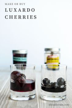 two glasses filled with liquid sitting on top of a wooden table