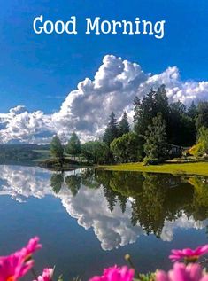 the words good morning are in front of a lake with pink flowers and green trees