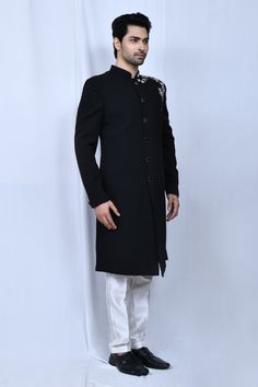 Black full sleeve sherwani with thread placement embroidery in floral pattern. Paired with cream straight pant.
Components: 2
Pattern: Embroidered
Type Of Work: Thread, floral
Neckline: Mandarin collar
Sleeve Type: Full sleeves
Fabric: Sherwani: Terry Rayon, Pant: Art Silk
Color: Black
Other Details: 
Front button detailing
Elasticated waistband
Side pockets
Occasion: Sangeet - Aza Fashions Elegant Designer Wear Sherwani With Straight Kurta, Unstitched Elegant Straight Kurta Sherwani, Elegant Unstitched Sherwani With Straight Kurta, Formal Straight Kurta Bandhgala With Intricate Embroidery, Elegant Straight Kurta Churidar For Formal Occasions, Elegant Formal Straight Kurta Churidar, Elegant Sherwani With Dabka On Straight Kurta, Elegant Formal Churidar With Straight Kurta, Formal Bandhgala With Intricate Embroidery