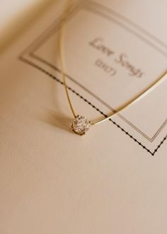 Introducing our stunning Essential Solitaire Necklace, a masterpiece of timeless beauty and personalised elegance. This piece features a 1-carat natural diamond on a sleek omega chain, adding a modern touch to classic sophistication. If you're interested in this piece with a specific diamond quality, color or size, please reach out to our custom team at info@cayejoaillier.com for more information. Please note: Omega styles are inherently fragile and require gentle handling. Avoid bending or pull Minimalist Solitaire Diamond Necklace For Everyday Luxury, Dazzling Single Diamond Wedding Necklace, Modern Diamond Wedding Necklace, Fine Jewelry Necklaces With Tension Setting For Anniversary, Fine Jewelry Necklace With Tension Setting For Anniversary, Minimalist Solitaire Necklace With Diamond Cut For Everyday Luxury, Fine Jewelry With Tension Setting In Cubic Zirconia, Fine Jewelry With Cubic Zirconia In Tension Setting, Luxury Single Diamond Necklace For Wedding