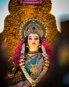 an idol is displayed in front of a backdrop