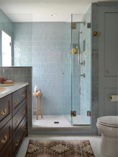 a bathroom with a toilet, sink and shower