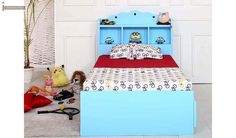 a child's bed with blue headboard and foot board, stuffed animals on the floor next to it