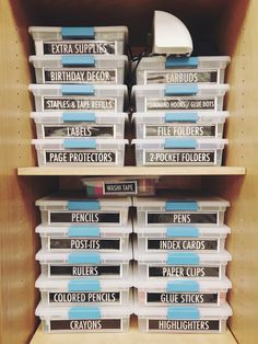 several plastic containers stacked on top of each other in a shelf with labels and tags