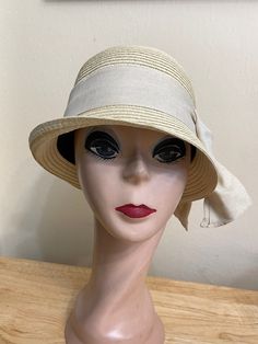 This soft Toyo Straw vintage-inspired natural beige cloche hat is lightweight and the hat will fit up to 22 5/8 inch head size which an inside sizing cord to adjust to your head size. The brim is 2 inches wide. The crown is about 4 1/2 inches tall. The bow band is made from cotton and linen blend material. NOTE: Please check the head size before purchase, I am happy to answer any questions you may have. There will be a 20% restocking fee for all returned hats. Luxury Beige Cloche Hat For Women, Fitted Beige Cloche Hat, Beige Cloche Hat For Church, Fitted Beige Cloche Hat For Church, Elegant Natural Color Bucket Hat, Classic Beige Straw Hat For Garden Party, Classic Mini Hats For Beach Spring Season, Classic Mini Hats For Beach In Spring, Beige Fedora Straw Hat For Garden Party