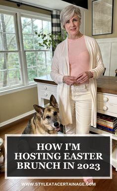 a woman standing next to a dog in a kitchen