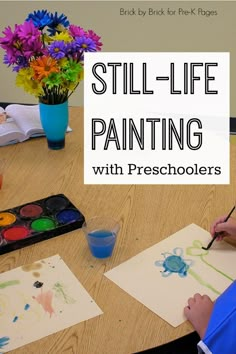 a young boy is painting with watercolors on paper and the words still - life painting are in front of him