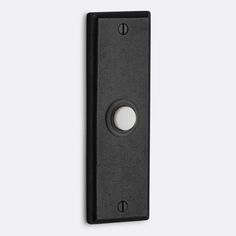 a black door handle with a round hole in the center and an oval button on the side