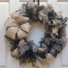 a black and gold wreath on a white door