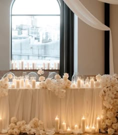 a table with candles and flowers on it