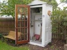 an outhouse is shown with the door open to show it's outside area