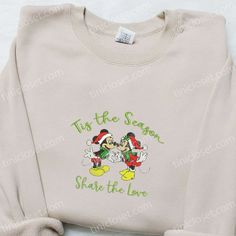 Mickey And Minnie Tis The Season Embroidered Shirt, Disney Characters Embroidered Hoodie, Christmas Embroidered Shirt Welcome to Tinicloset, where the holiday spirit comes to life with a dash of Disney magic! Imagine a world where excitement swirls through the air like snowflakes and joy twinkles like Christmas lights. Our store is a haven for those who seek unique and unforgettable holiday apparel. Among our enchanting collection, one gem shines brightly—the Mickey And Minnie Tis The Season emb Disney Embroidered Long Sleeve Tops, Disney Style Embroidered Long Sleeve Tops, Disney Mickey And Minnie, Hawaiian Shirt Women, Cool Fathers Day Gifts, Holiday Apparel, Mickey And Minnie Mouse, St Patrick's Day Gifts, Christmas Characters