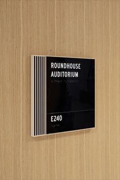 a wooden door with a sign that says roundhouse auditorium