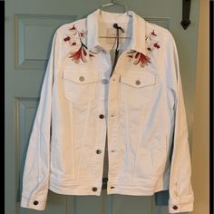 This Is A Denim Jacket With Floral Embroidery Design At Shoulders. Material Is A Cotton Blend With Stretch Fabric. Style Is Fitted. This Jacket Fits More Like A Size Large And Sleeves Are A Bit Long At Fitted, Not Loose. Casual White Embroidered Denim Jacket, White Embroidered Denim Jacket For Fall, Embroidered Relaxed Fit Outerwear For Fall, White Embroidered Cotton Denim Jacket, Embroidered White Denim Jacket For Spring, White Embroidered Denim Jacket For Spring, Embroidered Cotton Denim Jacket For Fall, Trendy Cotton Outerwear With Floral Embroidery, Embroidered Denim Button-up Jacket For Spring