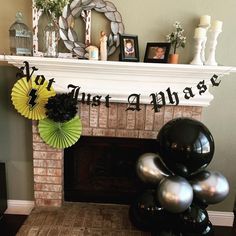 a fireplace with balloons and decorations on it