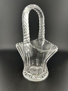 a clear glass basket sitting on top of a table