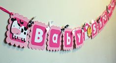 a baby shower banner hanging on the wall