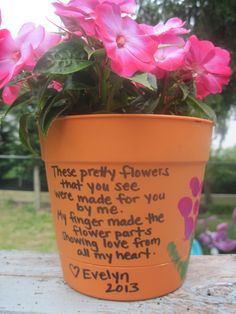 a flower pot with pink flowers in it on a table