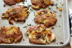 some food is sitting on a baking sheet and ready to be cooked in the oven