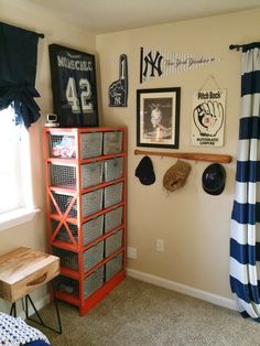 a bedroom with pictures on the wall and other items in the room, including a bookcase