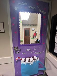 a purple door with a blue bag on it and some candy in front of it