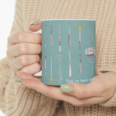 a woman holding a coffee mug with surgical instruments on it's side and the words you ve been in