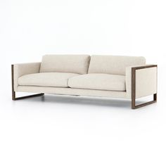 a white couch sitting on top of a wooden frame