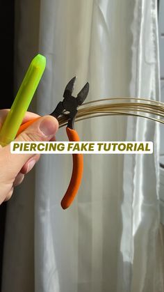 a person is holding scissors in their hand with the words percing fake material on it