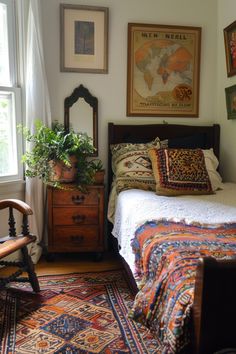 a bed sitting in a bedroom next to a window with lots of pictures on the wall