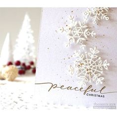 a card with snowflakes on it and the words peaceful christmas written in gold