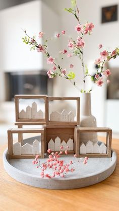 a vase with flowers in it sitting on top of a table next to some boxes