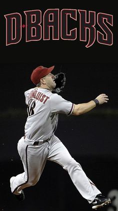 a baseball player in the air catching a ball