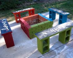 several different colored benches sitting on the sidewalk