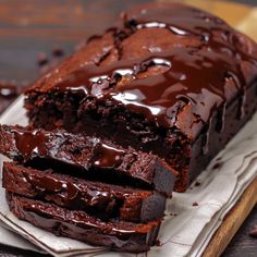 a loaf of chocolate cake sitting on top of a white plate