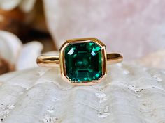 This classic bezel mounting contains a beautiful 2.00 ct. asscher cut lab created emerald. The stone measures approximately 8x8mm. The ring is available in sterling silver, and 14k white, yellow, or rose gold. Please send me a message if you need a size not listed. * This ring can be customized with any color center stone and is available with a matching band. All items are handmade by me in my shop in Woodbridge, NJ. Please message me with any questions. Shipping within the United States is com Formal Octagon Emerald Ring With Bezel Setting, Elegant Asscher Cut Emerald Ring With Bezel Setting, Fine Jewelry Octagon Emerald Ring With Bezel Setting, Green Octagon Emerald Ring With Bezel Setting, Classic Emerald Ring With Asscher Cut And Bezel Setting, Emerald Asscher Cut Jewelry With Bezel Setting, Emerald Jewelry With Bezel Setting In Asscher Cut, Gift Emerald Ring With Radiant Cut And Bezel Setting, Emerald Asscher Cut Ring