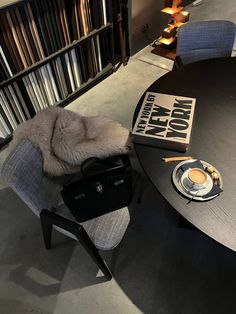 a chair with a fur on it next to a table