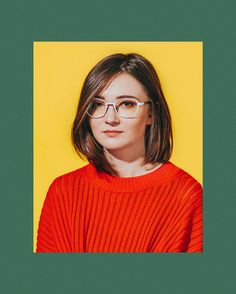 a woman wearing glasses standing in front of a yellow background