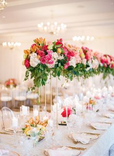 a long table is set with flowers and candles for an elegant wedding or special event